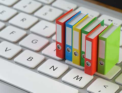 Colourful Miniature File Folders on a keyboard