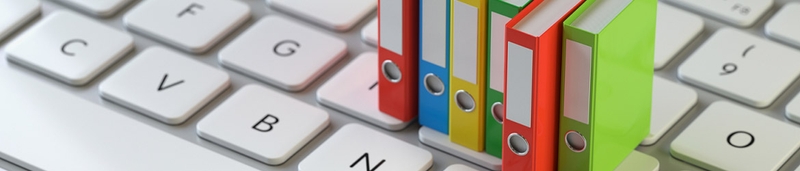 Colourful miniature file folders on a keyboard