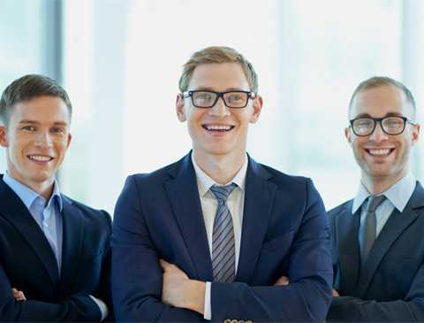 Three smiling gentlemen in suits
